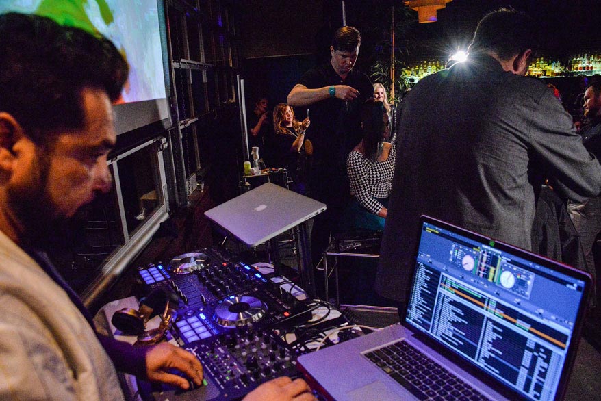A live DJ keeps the energy high at an Elevate event.