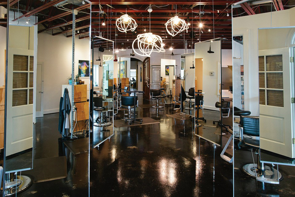 Suspended mirrors create individual stylist spaces inside Salon U. Photo by Graham Yelton.